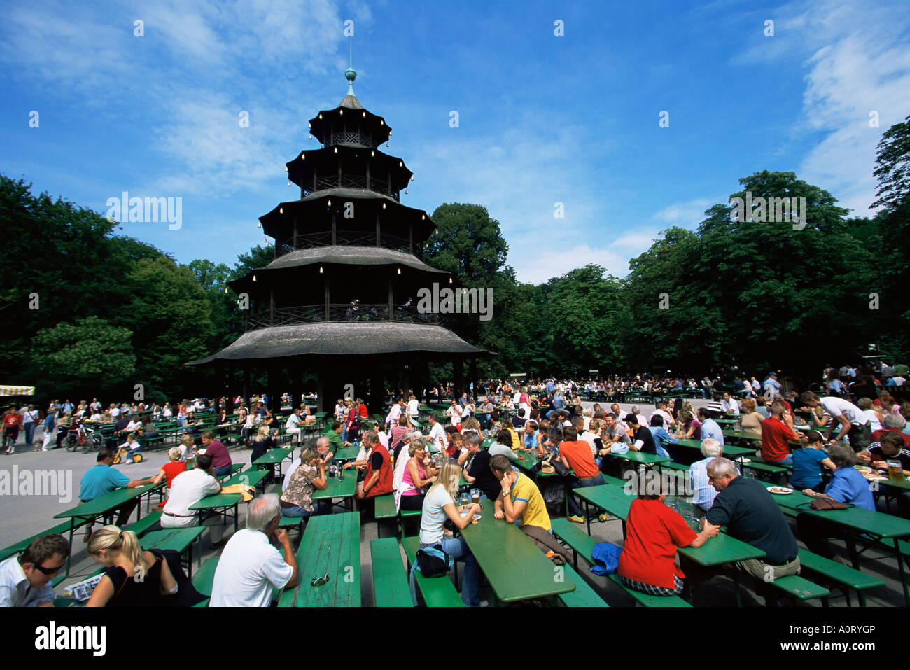 People sitting at the Chinese Tower beer garden in the Englischer Garten Munich Bavaria Germany Europe Stock Photo