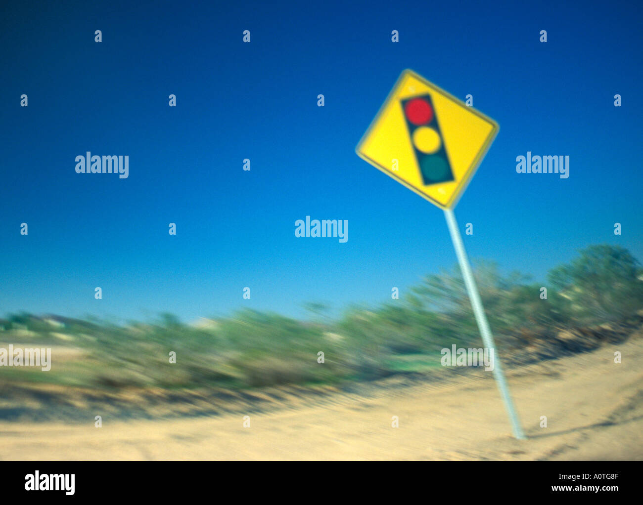 Blurry distorted photo of traffic lights ahead warning sign Stock Photo