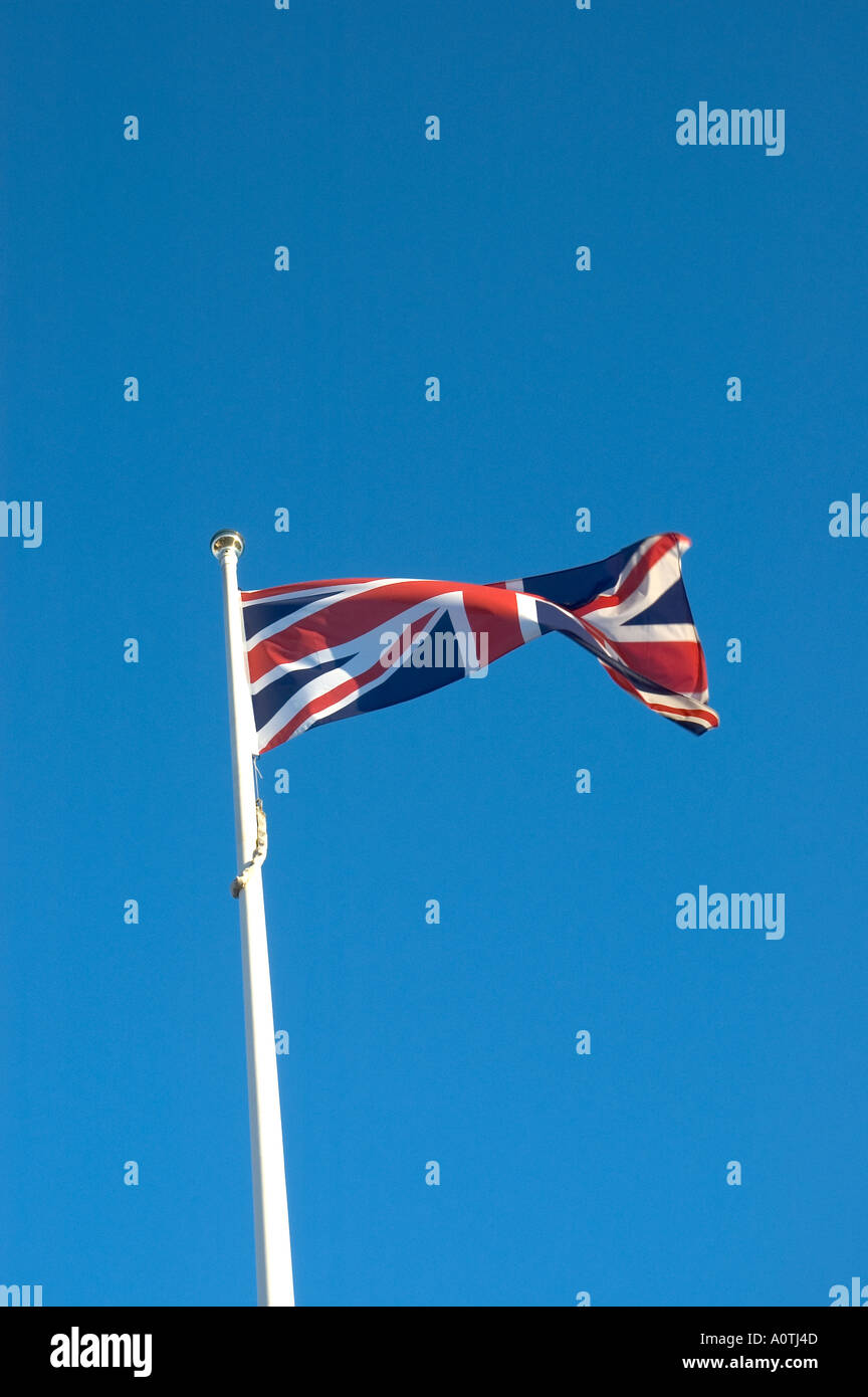 The British Union Jack flag flies proudly against a blue sky in the ...