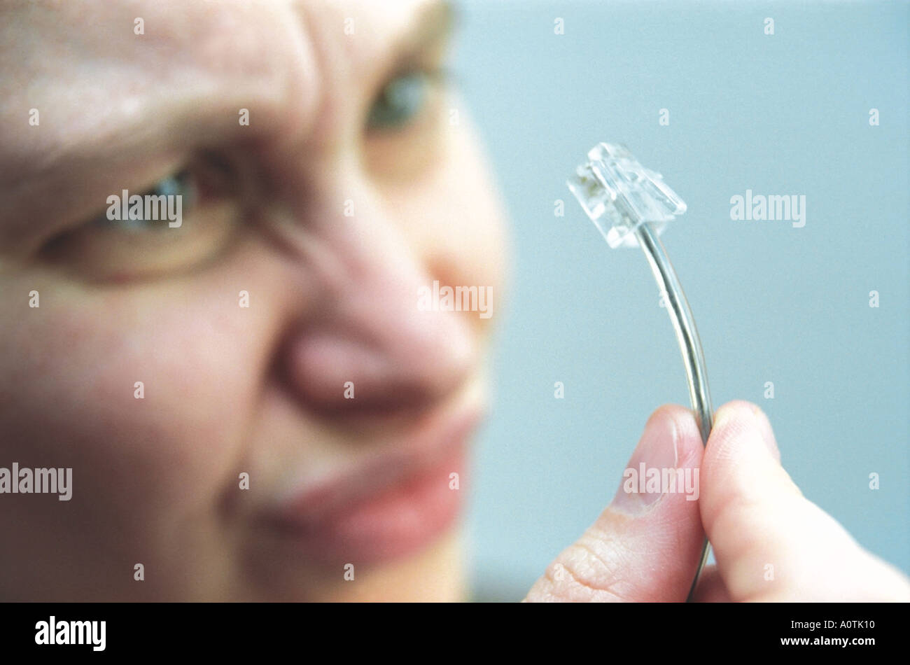 A woman is looking over a telephone plug  Stock Photo