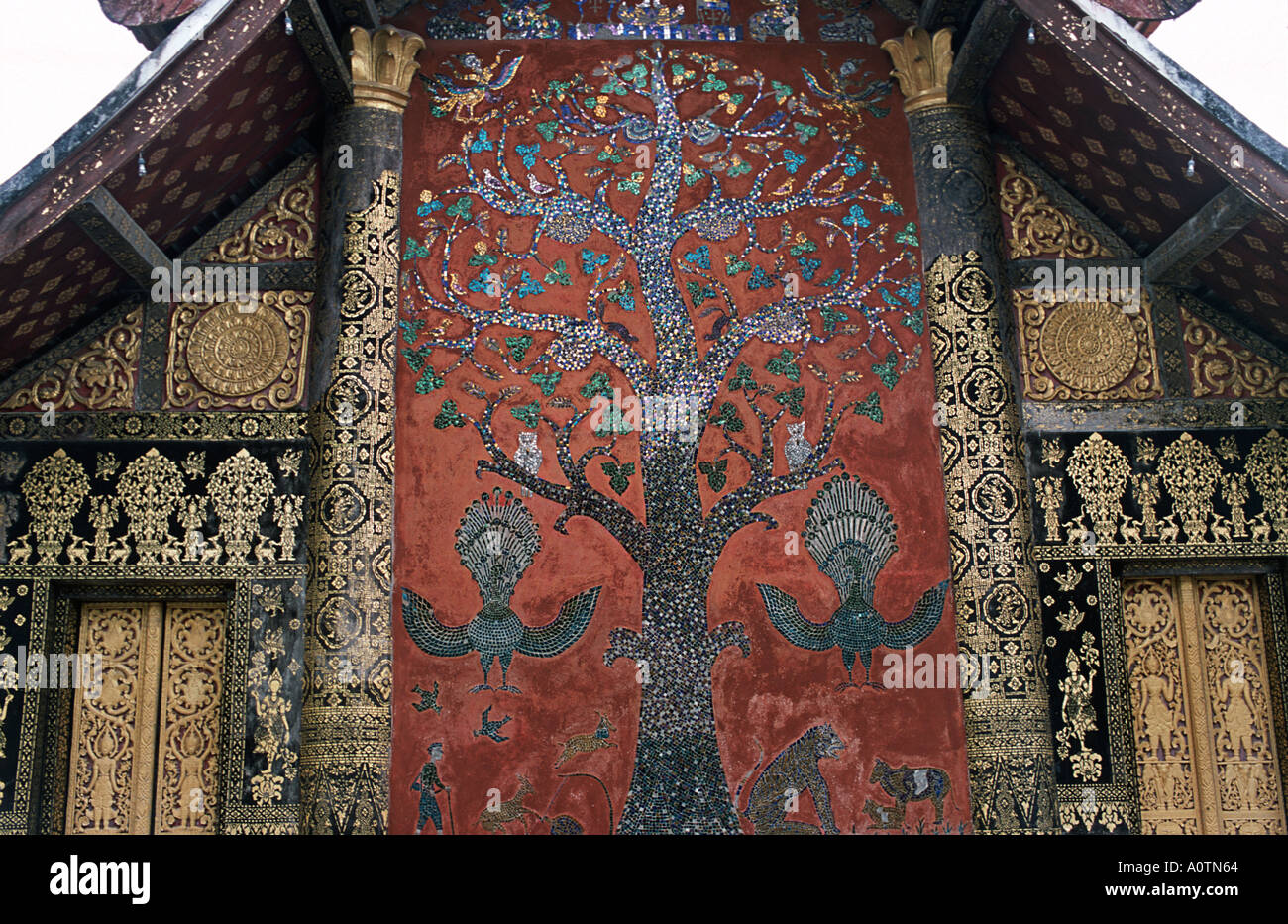 Xieng Tree Ornately decorated rear wall of the sim at Wat Xieng Thong Luang ...