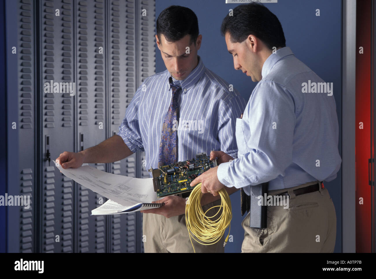 Technicians working on telecommunications hardware Stock Photo