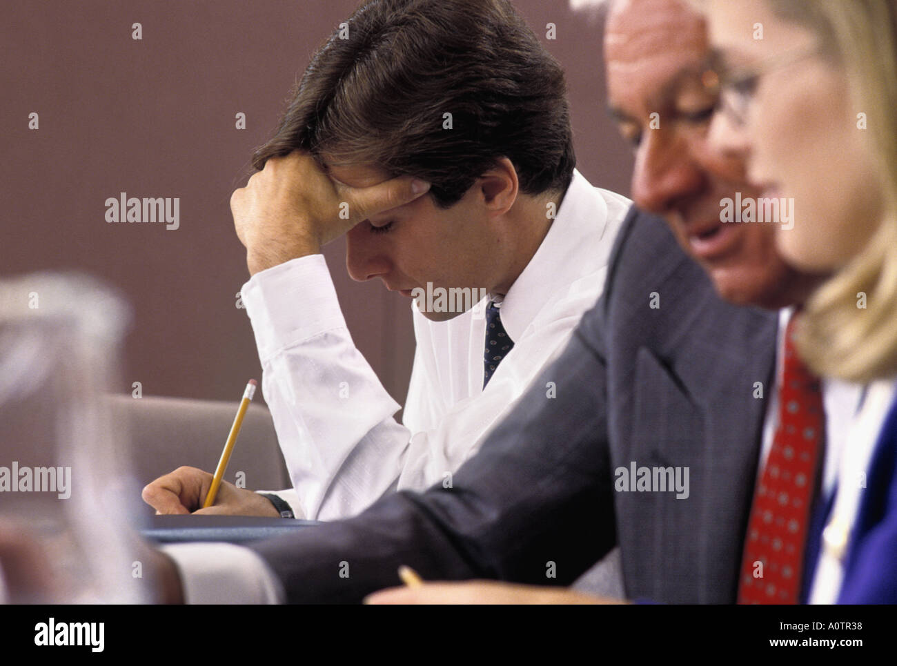 Caucasian businessman making notes during meeting Stock Photo