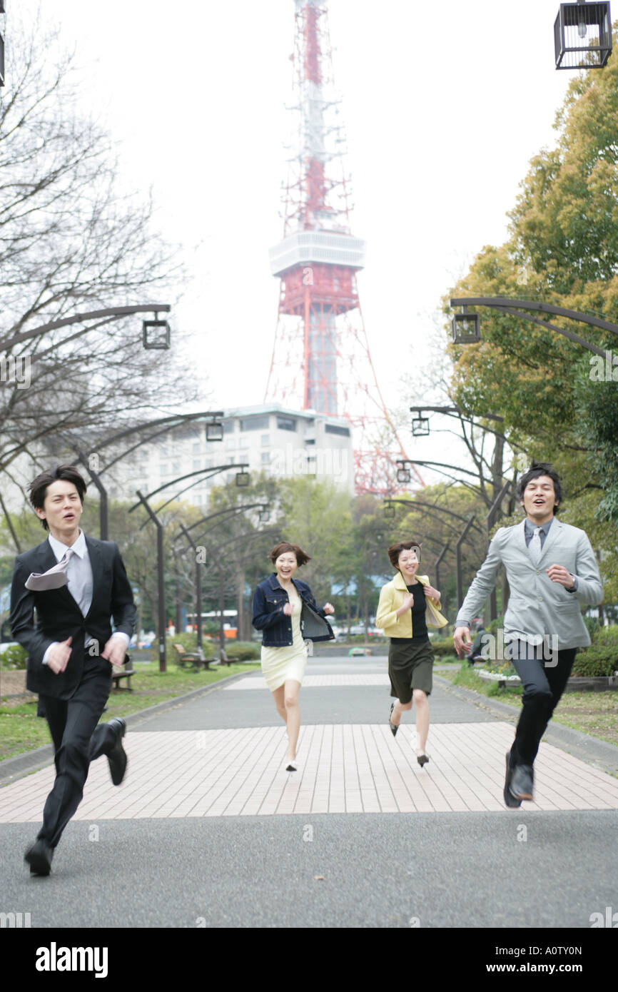 Two businessmen and two businesswomen running in a park Stock Photo