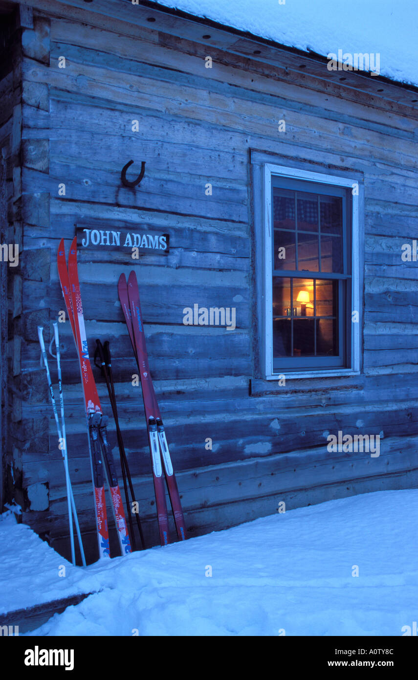 Cross country skis outside a log cabin Stock Photo