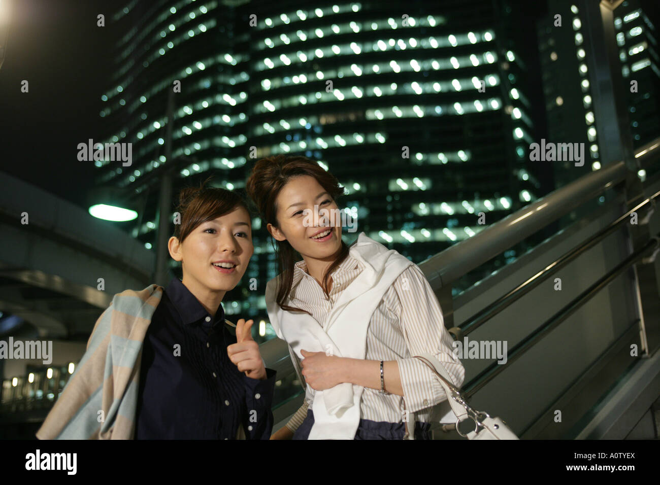 Close-up of two Young Women standing together and smiling Stock Photo ...