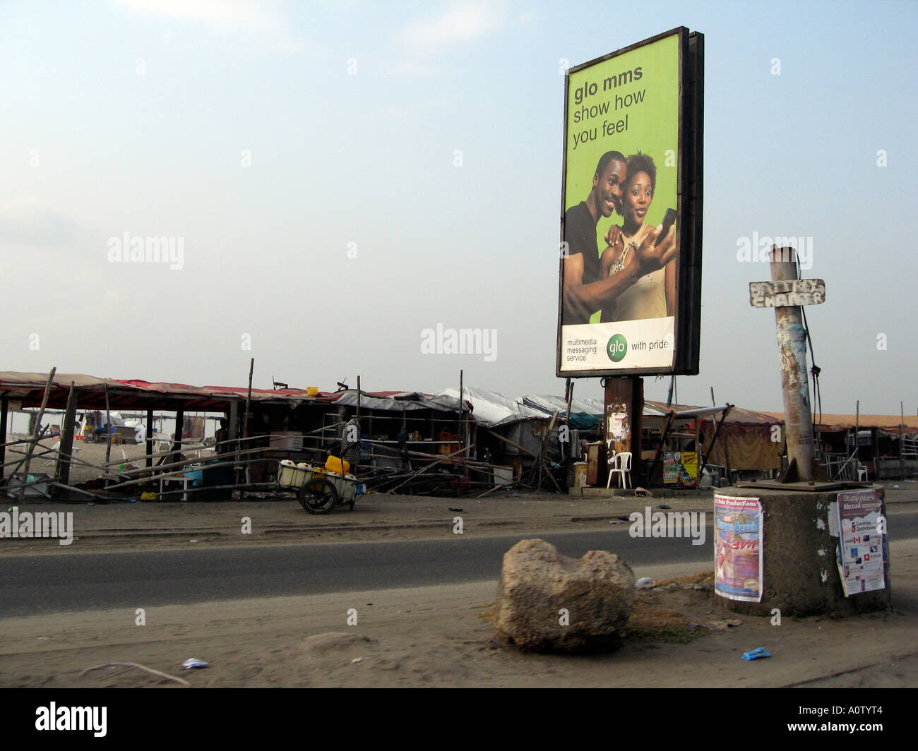 GLO pre pay phone card advertising and shanty bar on beach side road in Lagos Stock Photo