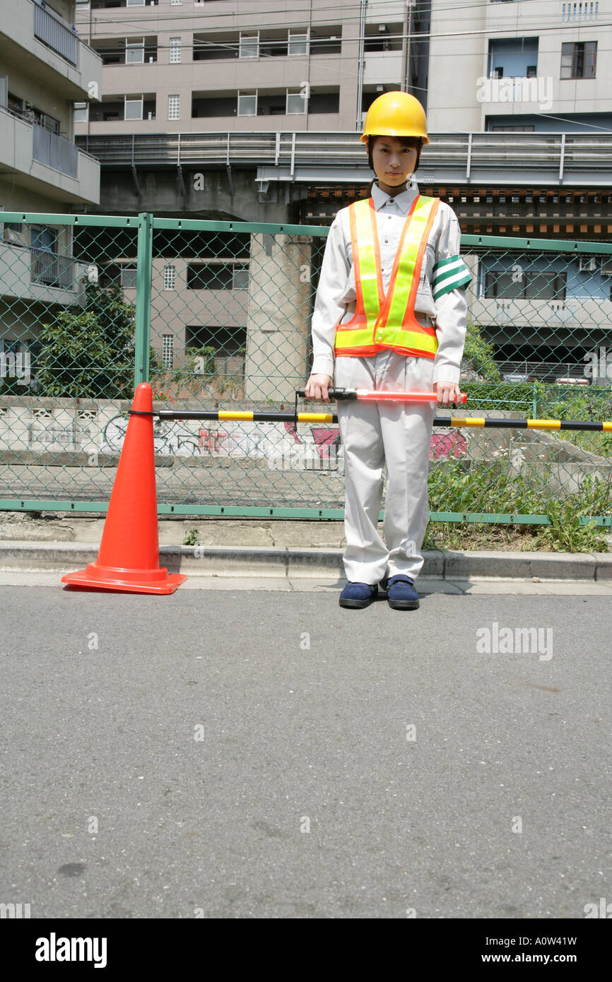 Portrait of a female traffic cop holding a nightstick Stock Photo