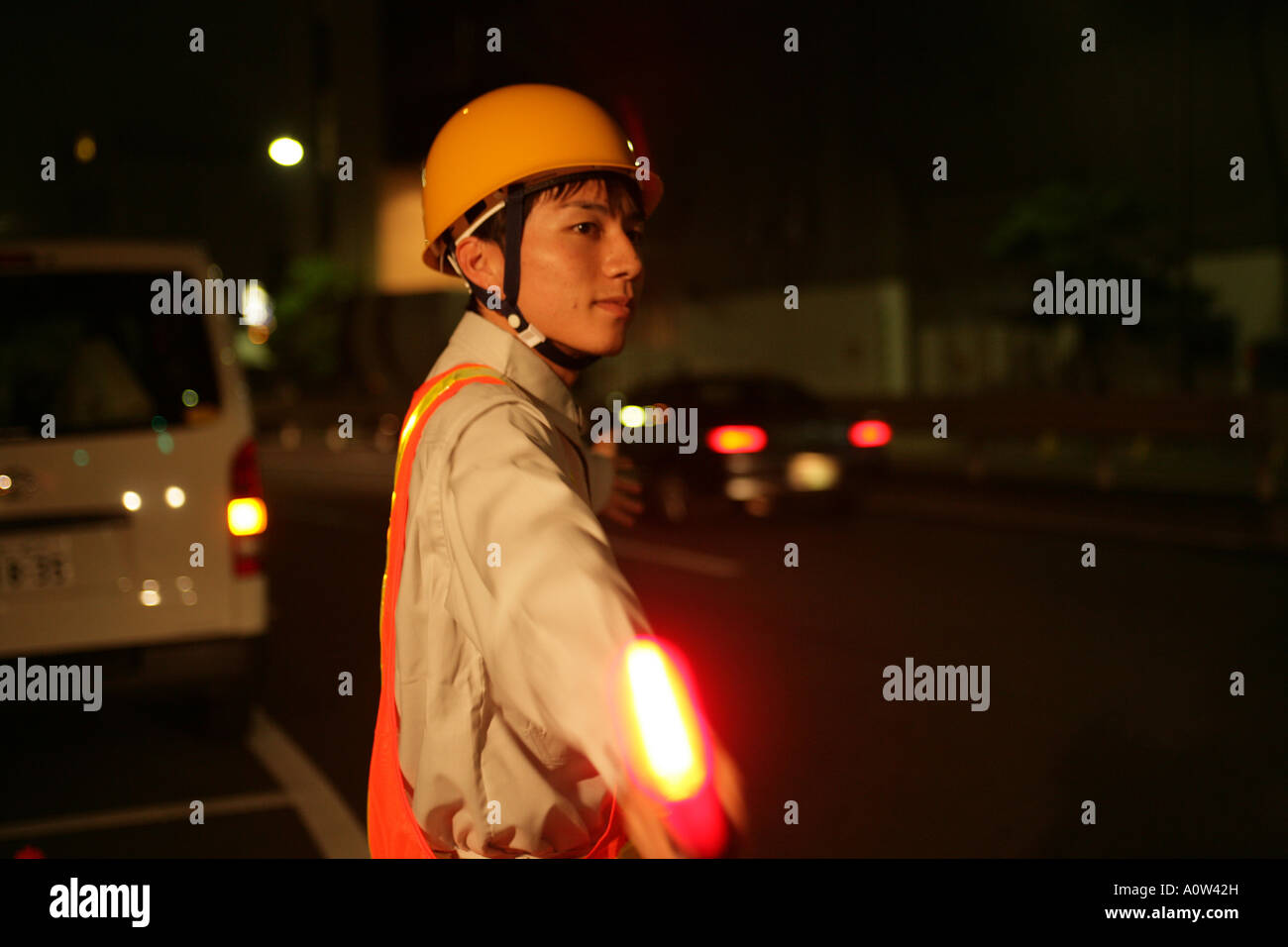 Side profile of a traffic cop holding a nightstick Stock Photo