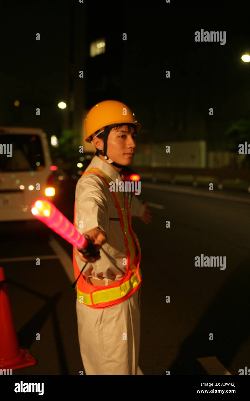 Side profile of a traffic cop holding a nightstick Stock Photo