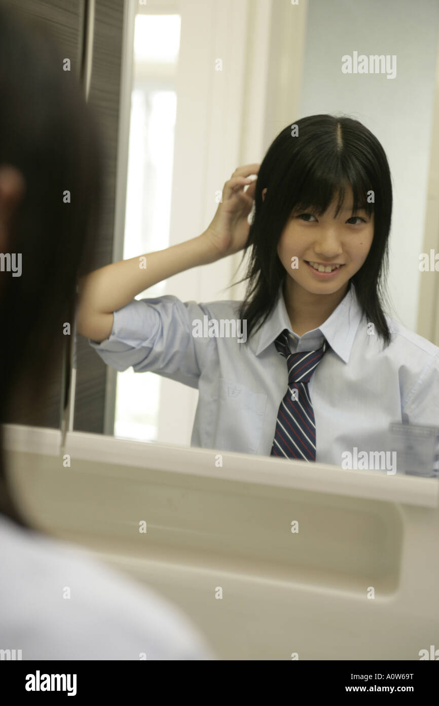 Reflection of a teenage girl in a mirror Stock Photo - Alamy