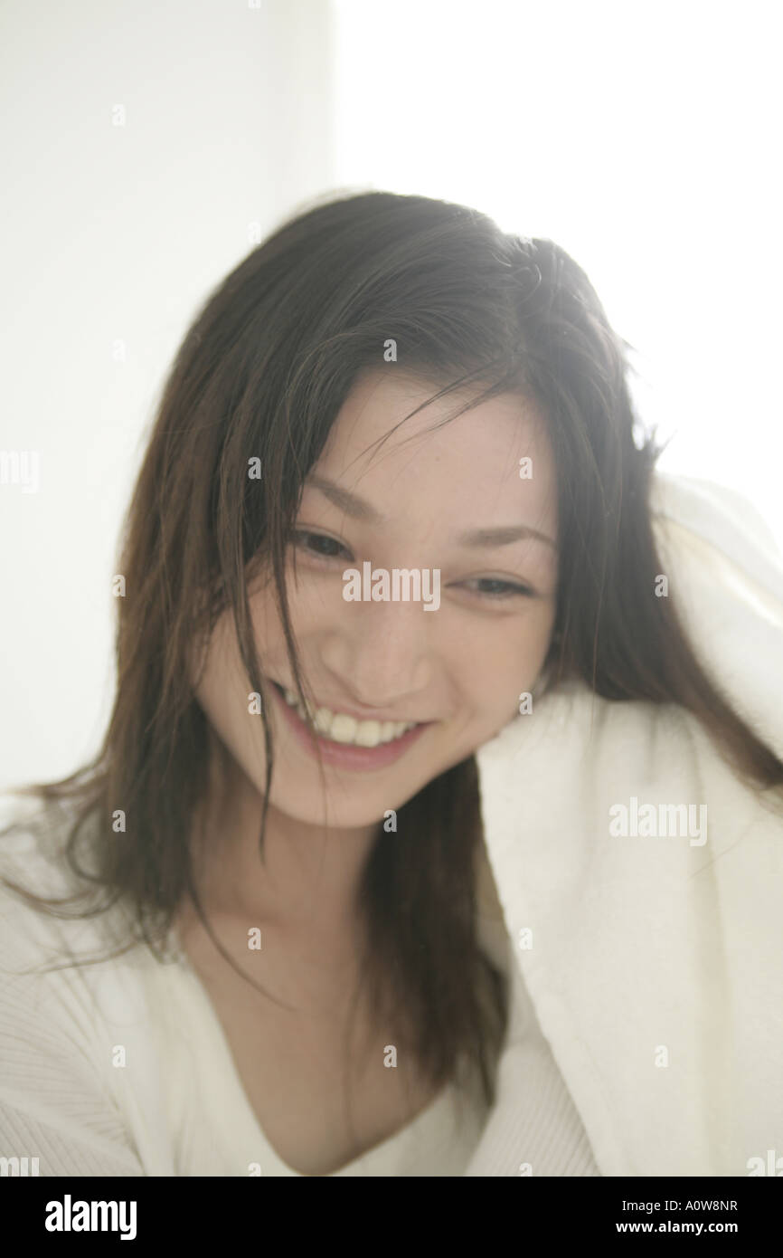 Close up of a young woman drying her hair with a towel Stock Photo - Alamy