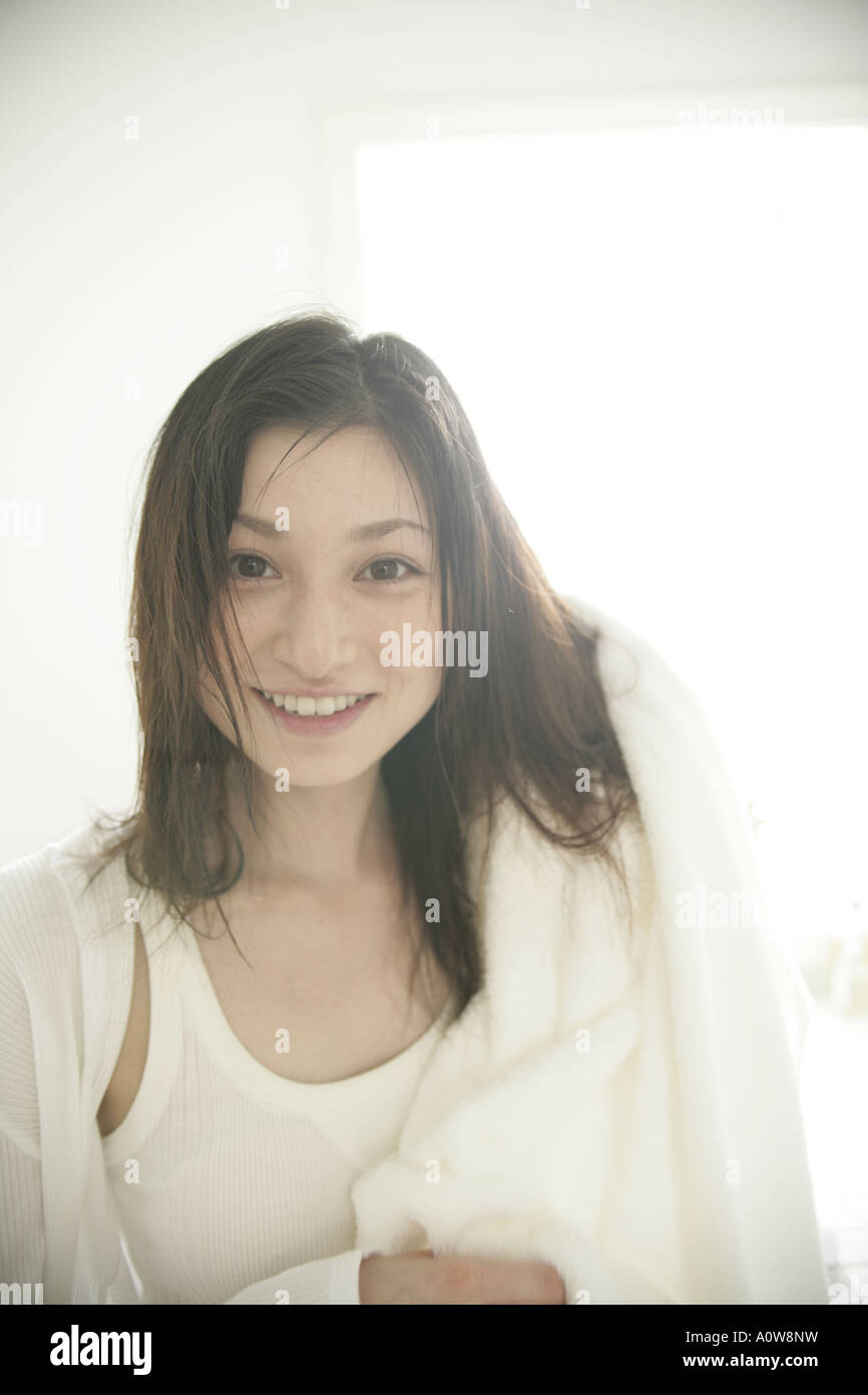 Portrait of a young woman drying her hair with a towel Stock Photo - Alamy