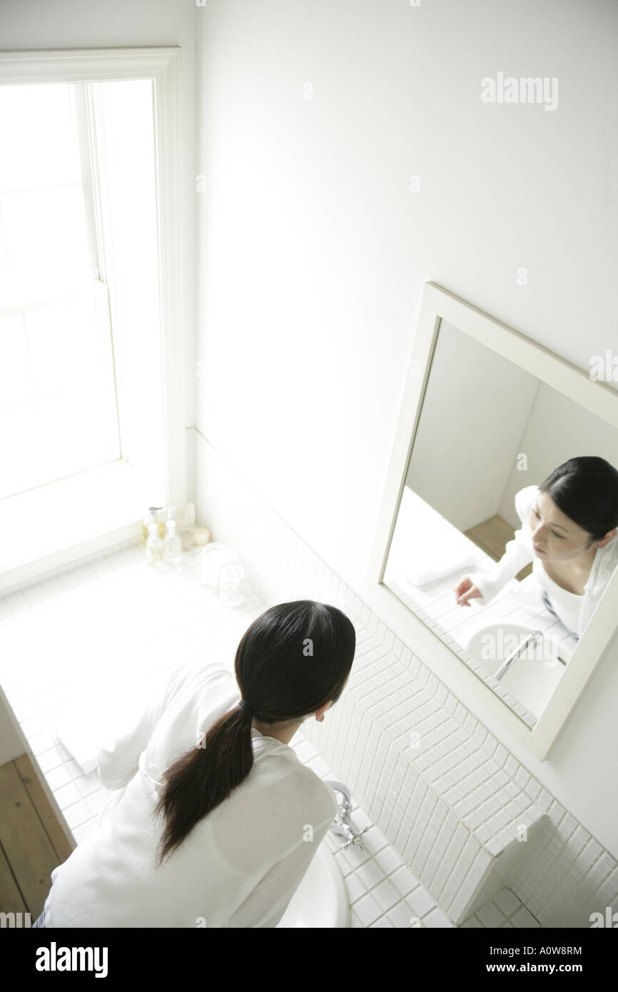 High angle view of a young woman looking in a mirror Stock Photo - Alamy