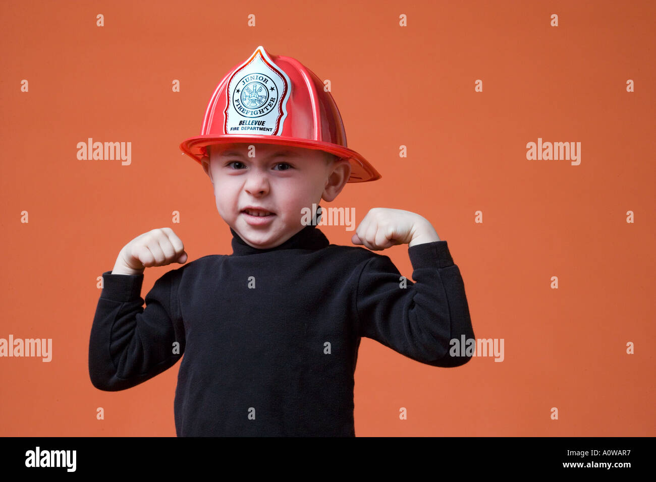 Portrait Little Caucasian Boy in Fireman hat Stock Photo