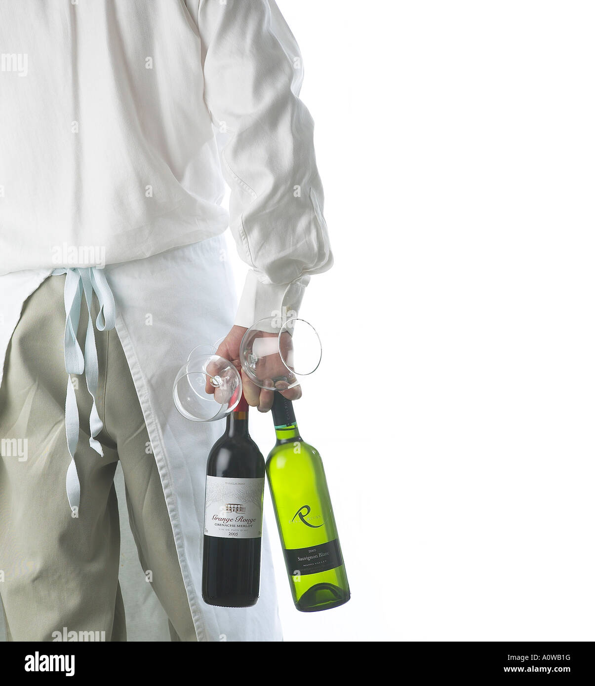 A WINE WAITER CARRYING TWO BOTTLES OF WINE SEEN FROM THE BACK Stock