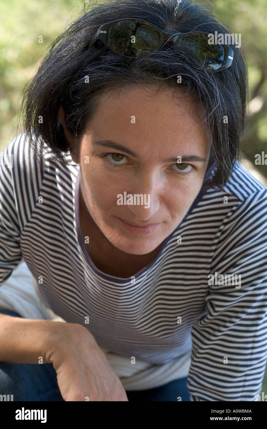 Portrait of a woman wearing a stripy top and looking annoyed. Stock Photo