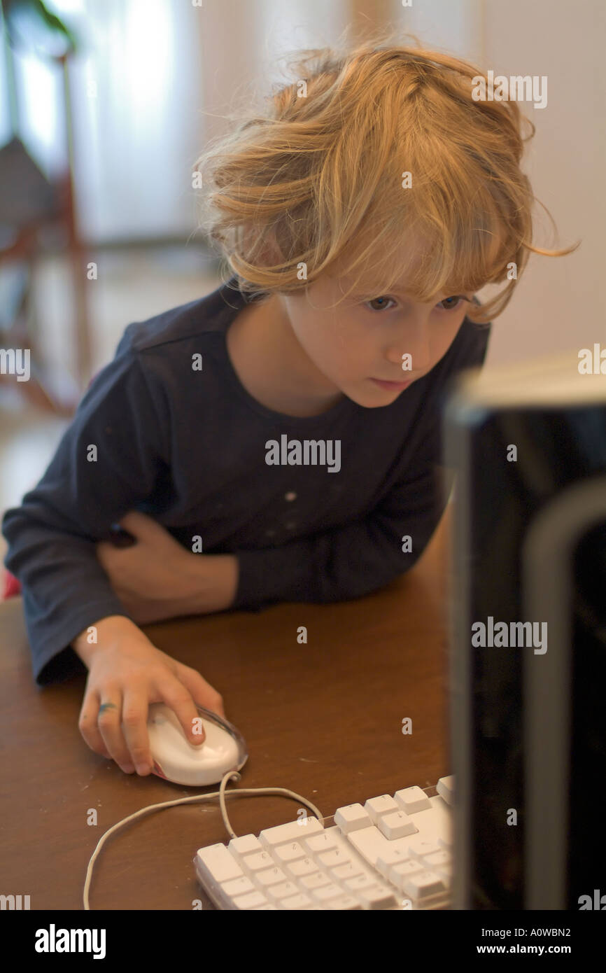 Little girl using a desktop computer at home Stock Photo - Alamy