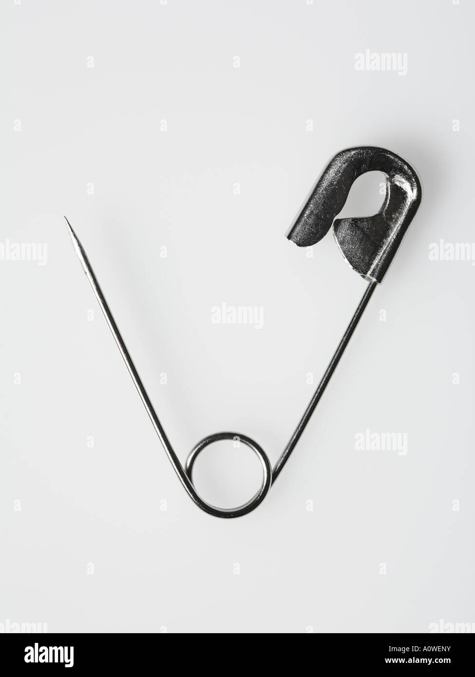 Open safety pin on plain white background Stock Photo Alamy