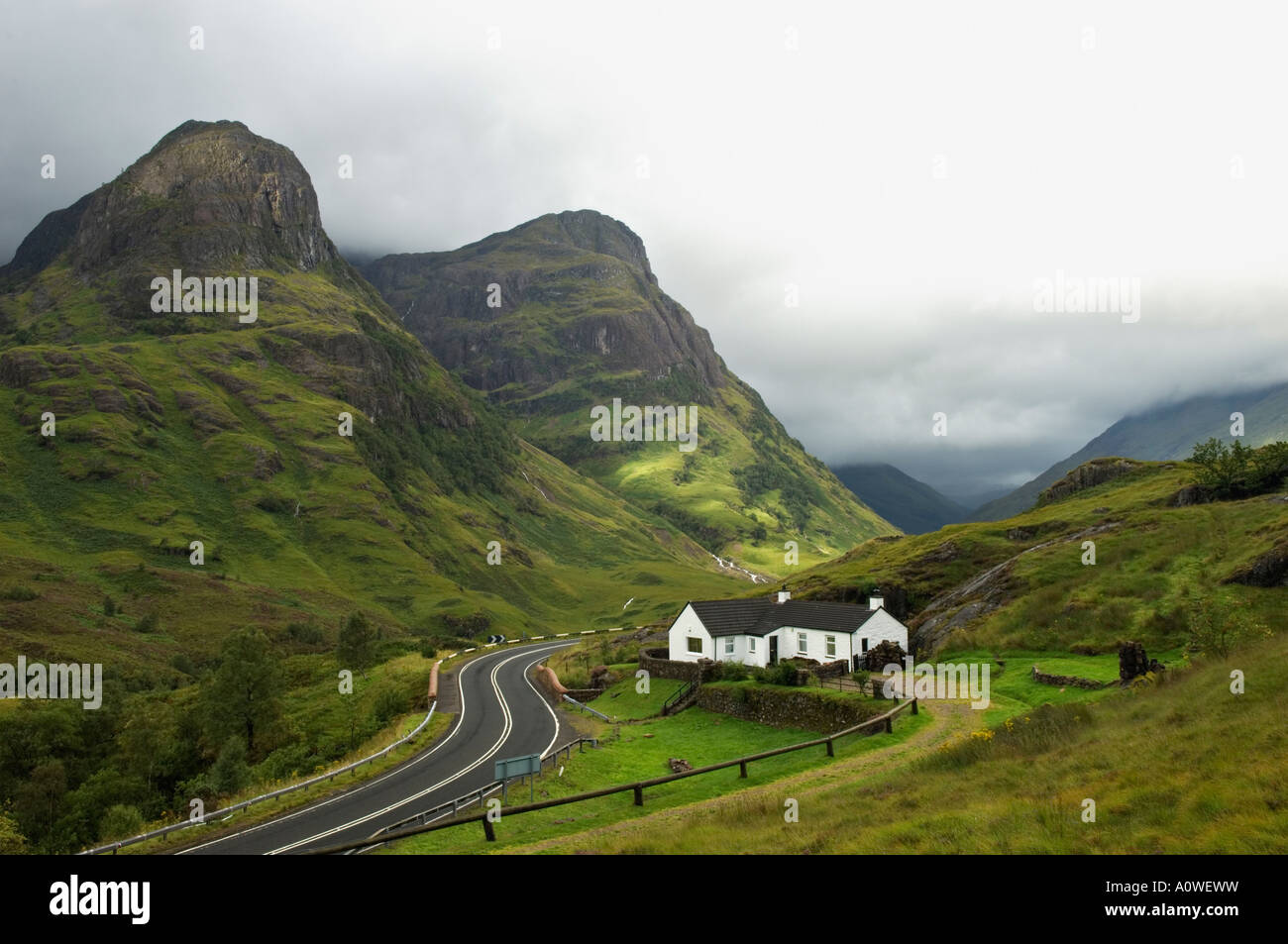 Breaking Storm Over Cottage in Pass of Glencoe Argyll Scotland Stock Photo