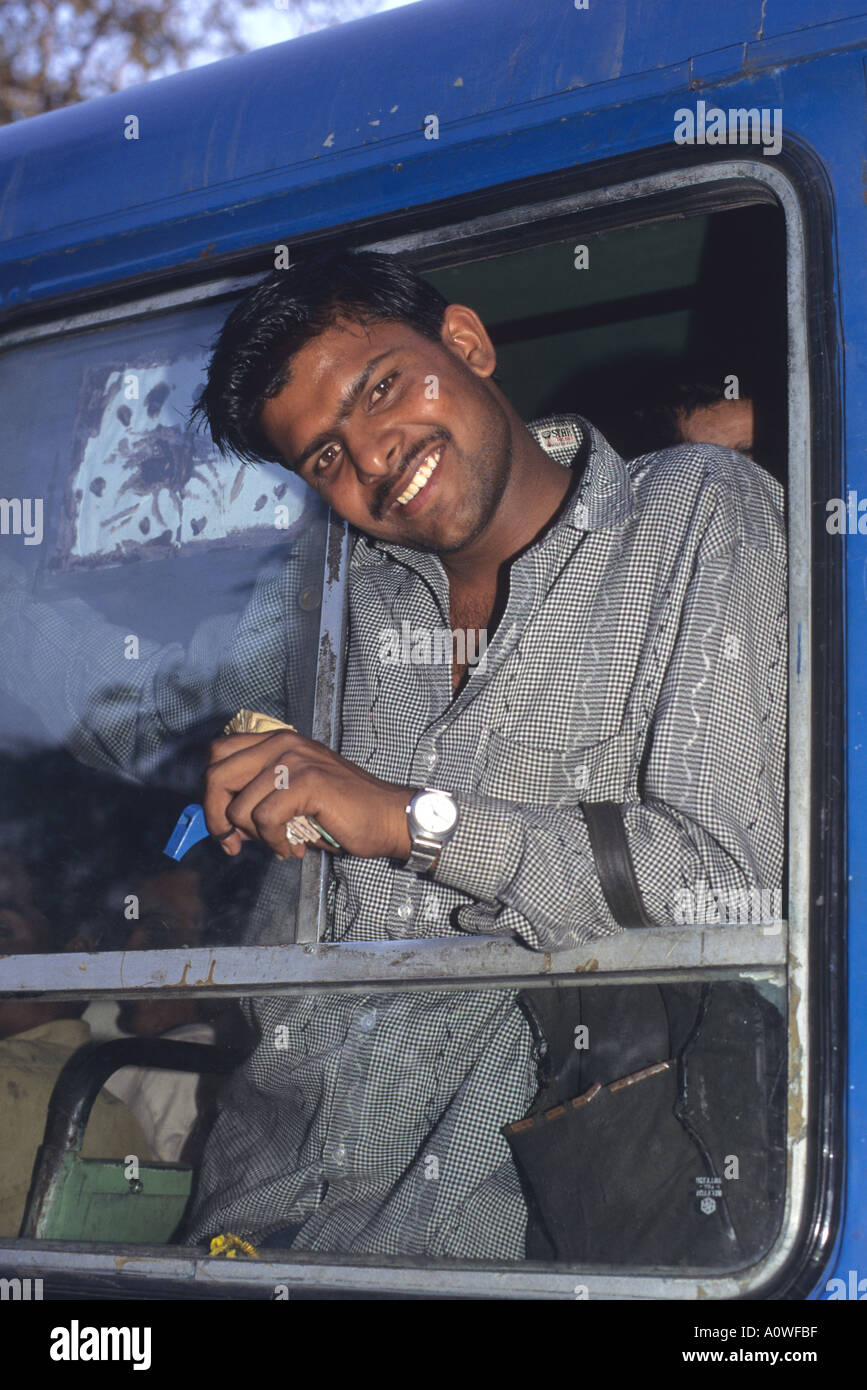 Bus conductor in New Delhi India  Stock Photo
