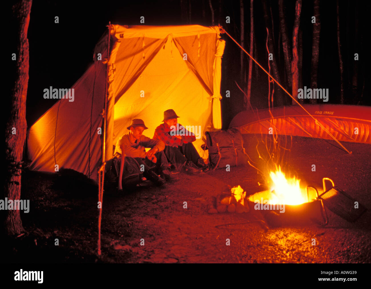 Campers around a fire in the Boundary Waters Canoe Area Wilderness Minnesota Stock Photo