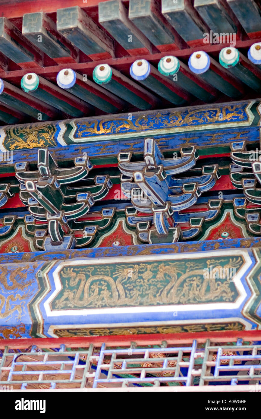 CHINA BEIJING The Summer Palace Yiheyua, Detail of carvings and paintings under the eaves of the curved roof Stock Photo