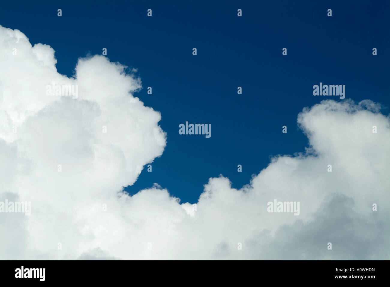 Cumulus clouds against deep blue sky Stock Photo - Alamy
