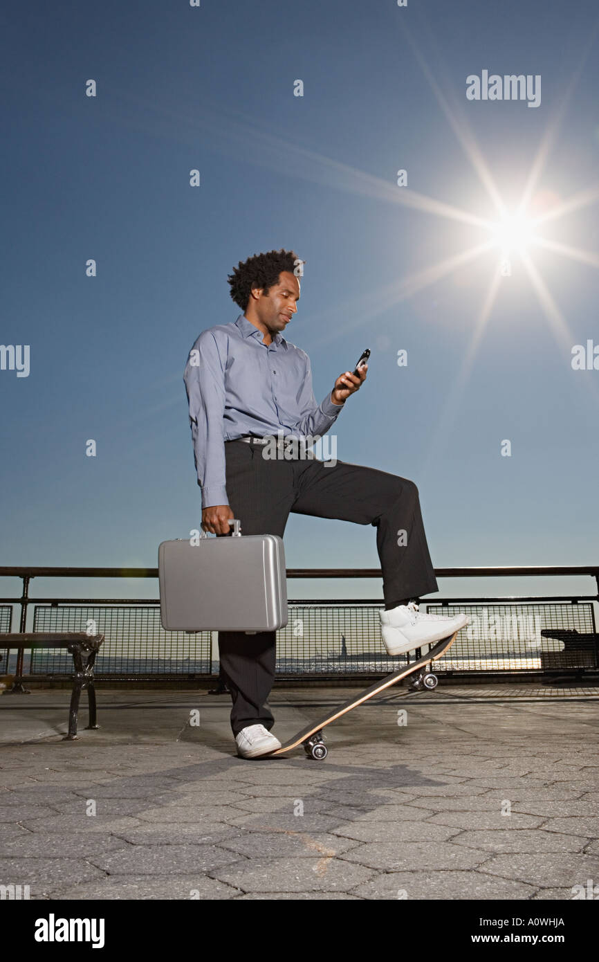 Businessman on a skateboard Stock Photo