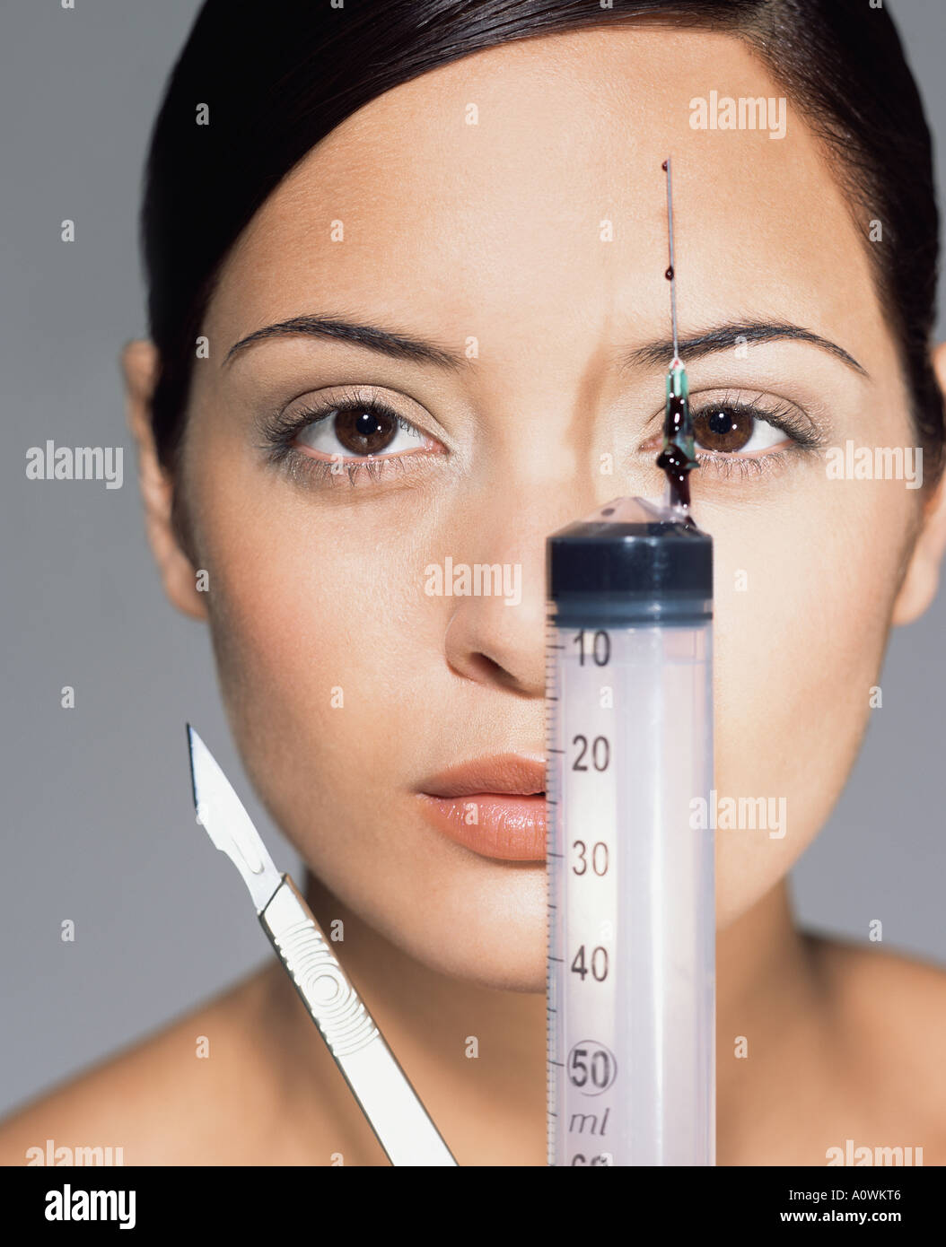 Woman with syringe and scalpel Stock Photo Alamy