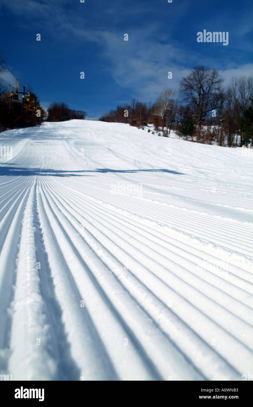 Perfectly Groomed Ski slope on a sunny day Stock Photo