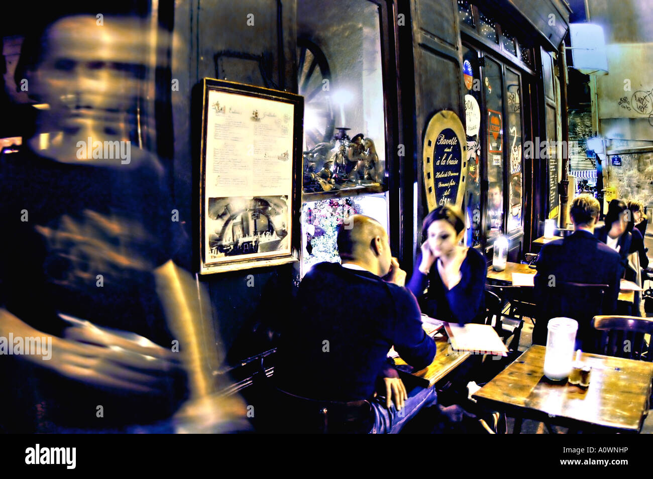 PARIS France, Couples Sharing Meals on Tables, Sidewalk Terrace at Local 'French Bistro Restaurant' 'L'Ecurie' at Night Stock Photo