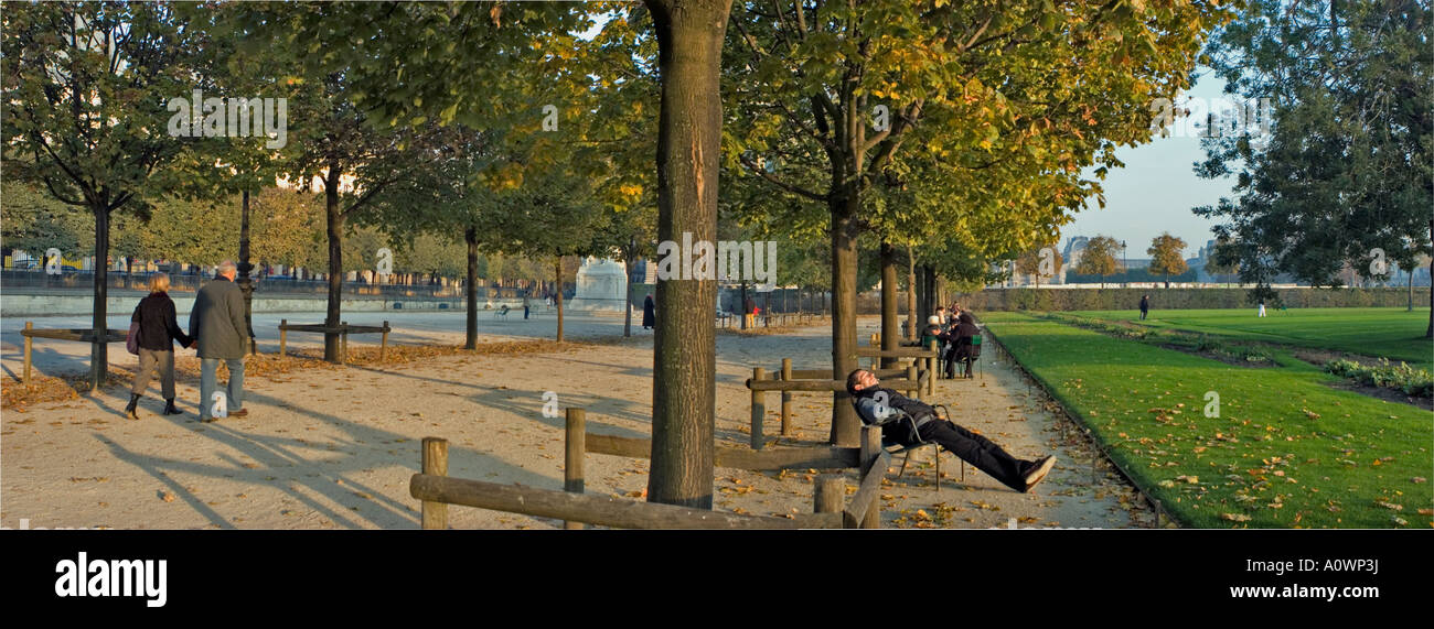 Paris France Public Parks 'Tuileries Park' in Autumn People Promenading Panoramic VIew Trees Bench Stock Photo