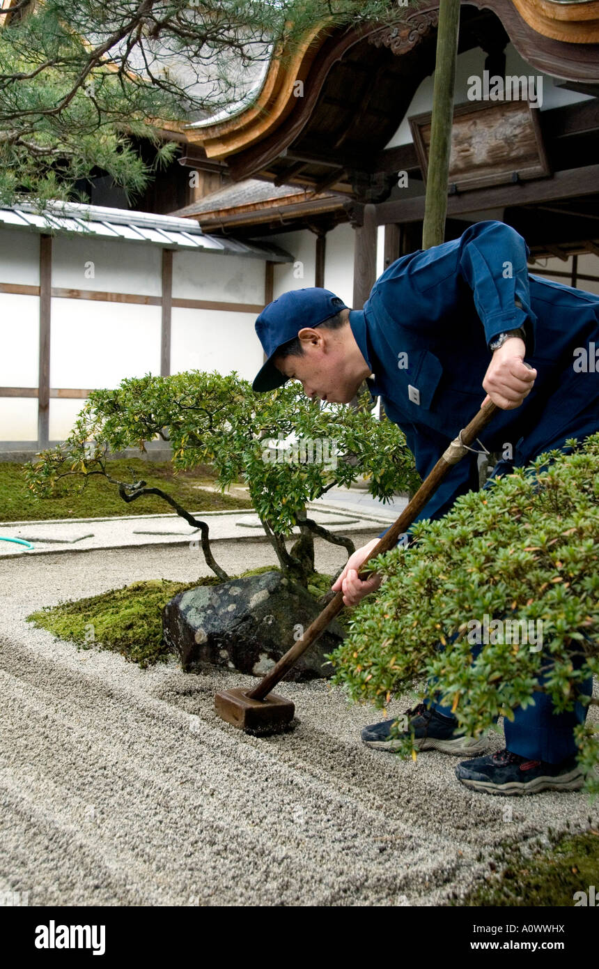 Gardener raking a new zen garden at the Silver Pavilion Ginkakuji