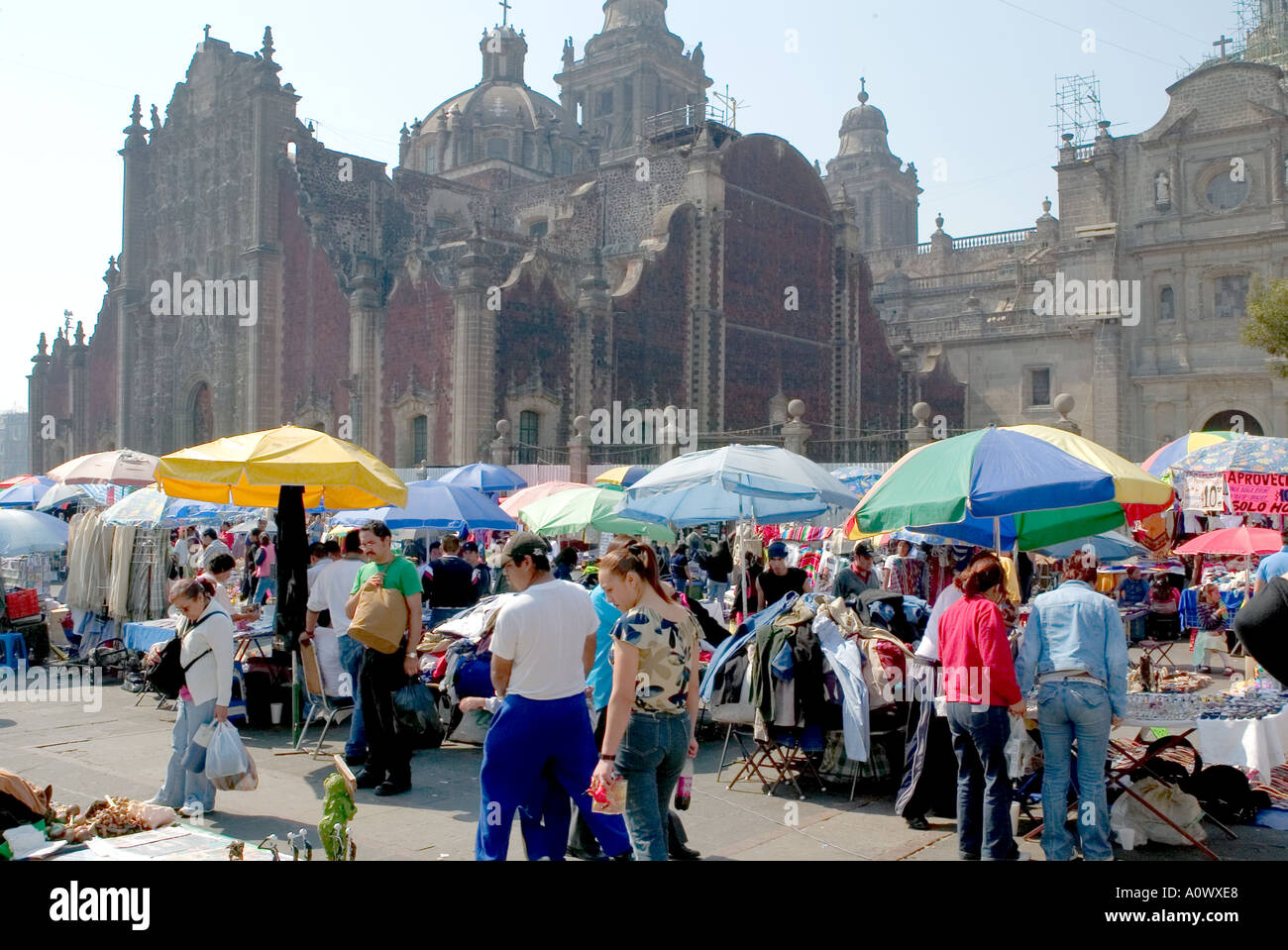 Market stalls and shoppers in the Zocalo Mexico City with the Metropolitan Cathedral behind Stock Photo
