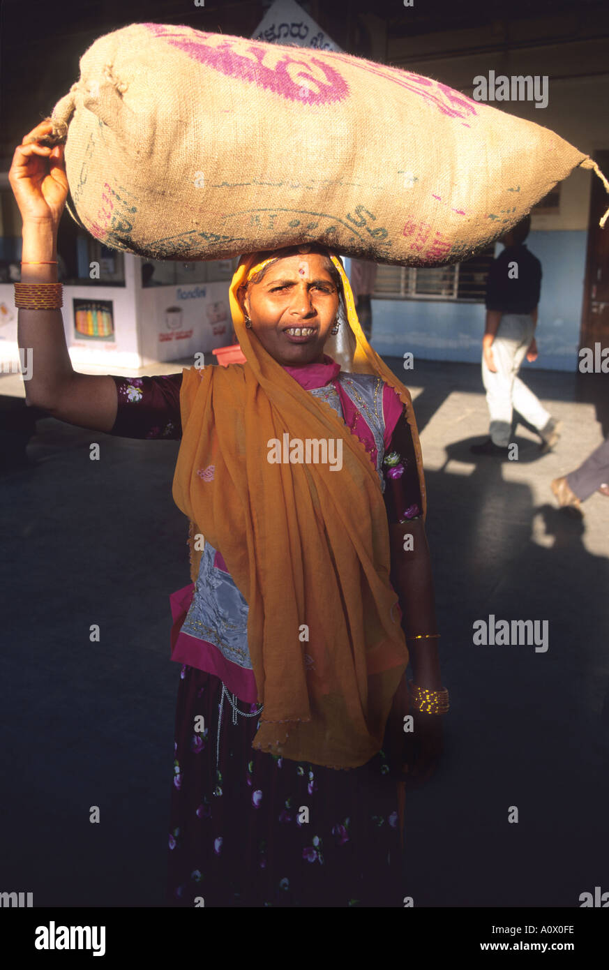 Indian woman carrying a bag on her head in India Stock Photo Alamy