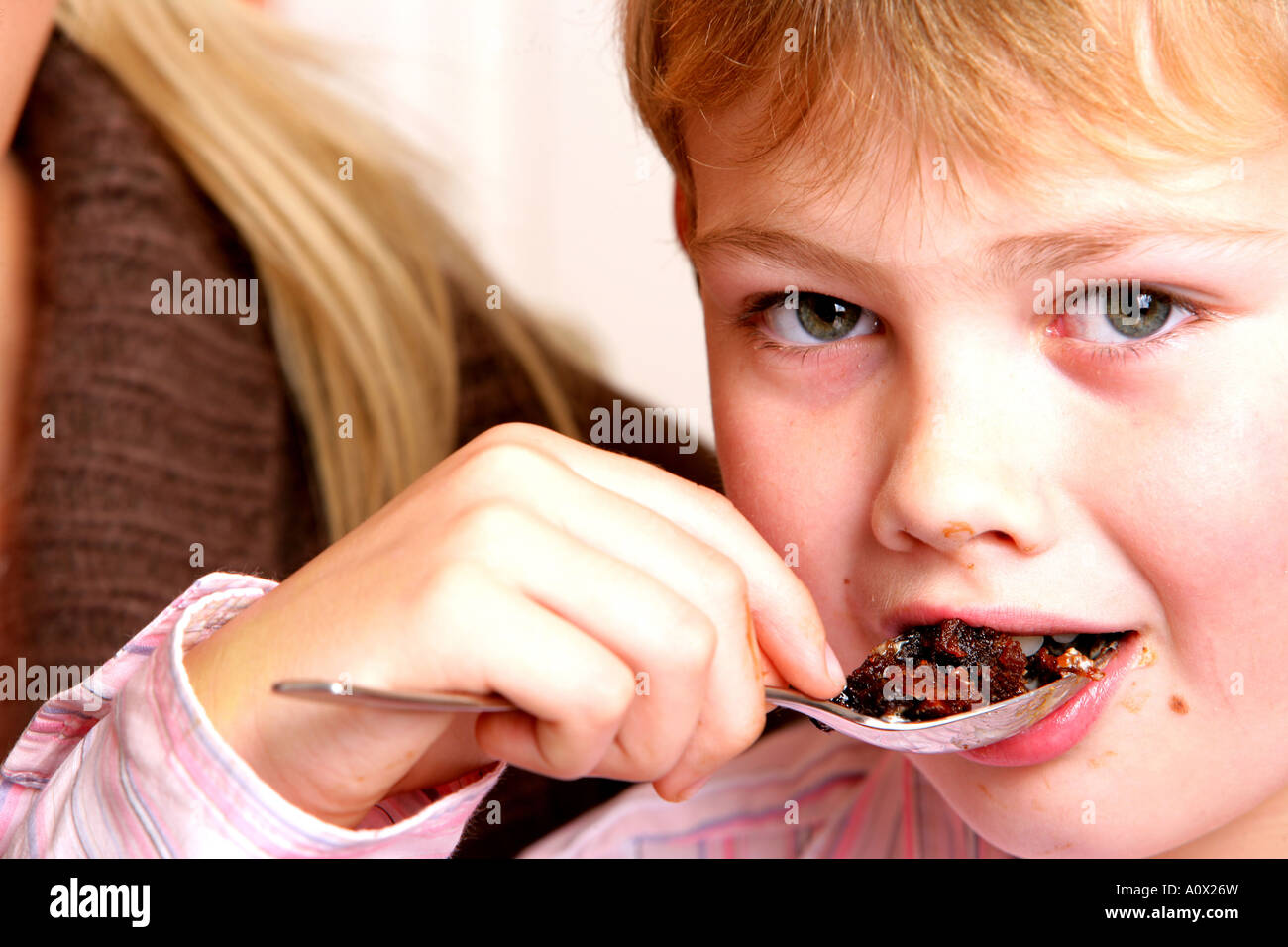 Young Boy Eating Christmas Pudding Model Released Stock Photo ...