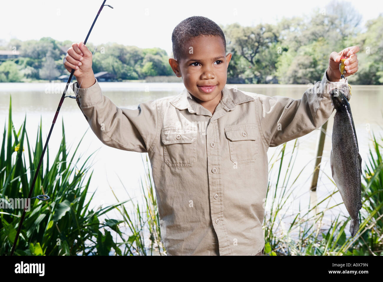 Young African boy with fishing pole and fish Stock Photo - Alamy