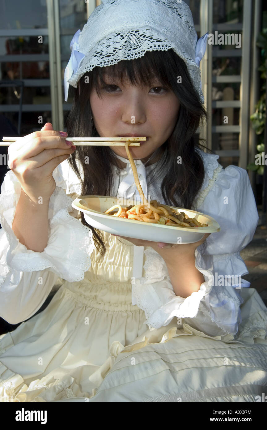 Tokyo subculture teenage girl eating noodles Harajuku Yoyogi koen park Tokyo Honshu Japan Asia Stock Photo