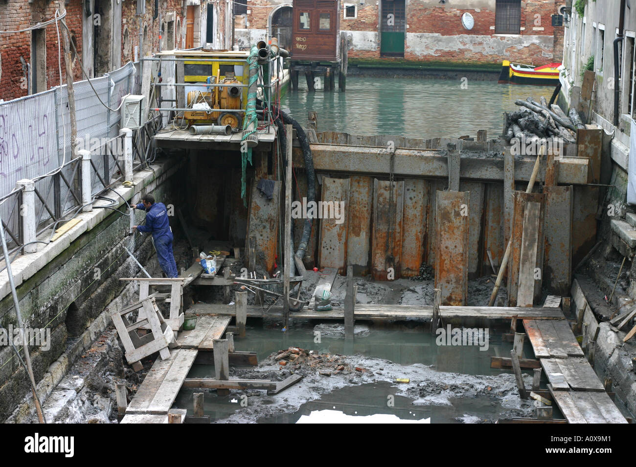 Canal being dredged in Venice Italy  revealing city's foundations Stock Photo