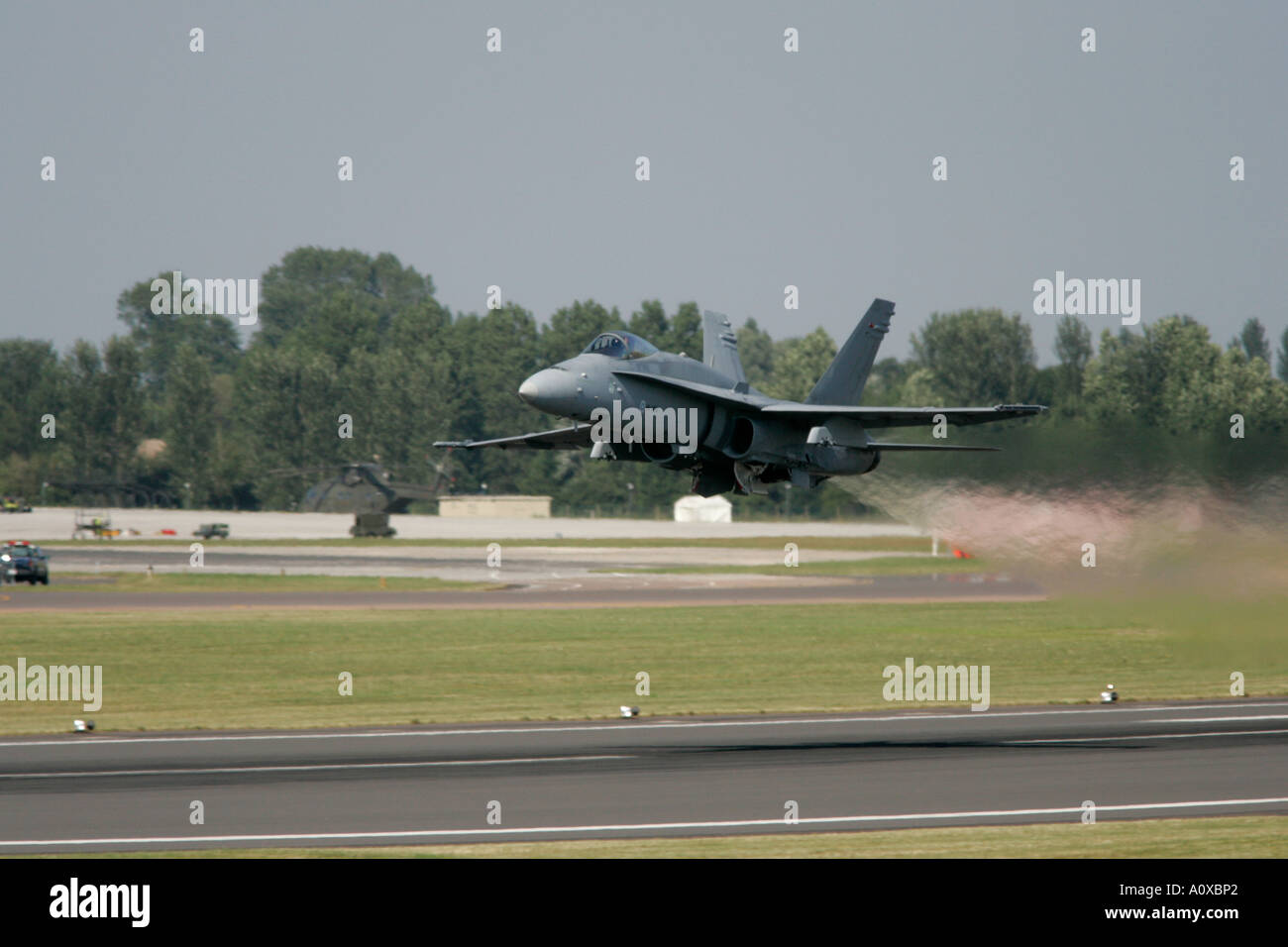 Finnish AF F 18C Hornet takes off from runway with full afterburner and jet wash RIAT 2005 RAF Fairford Stock Photo
