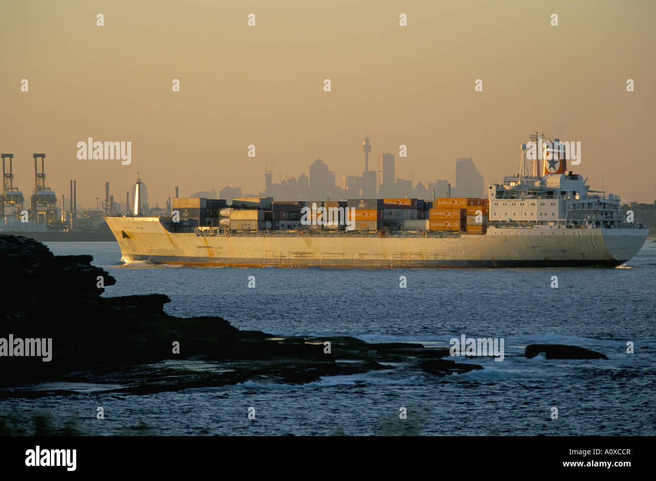 Container ship entering Botany Bay Sydney s port and landfall site of Captain Cook s Endeavour Sydney New South Wales Australia Stock Photo