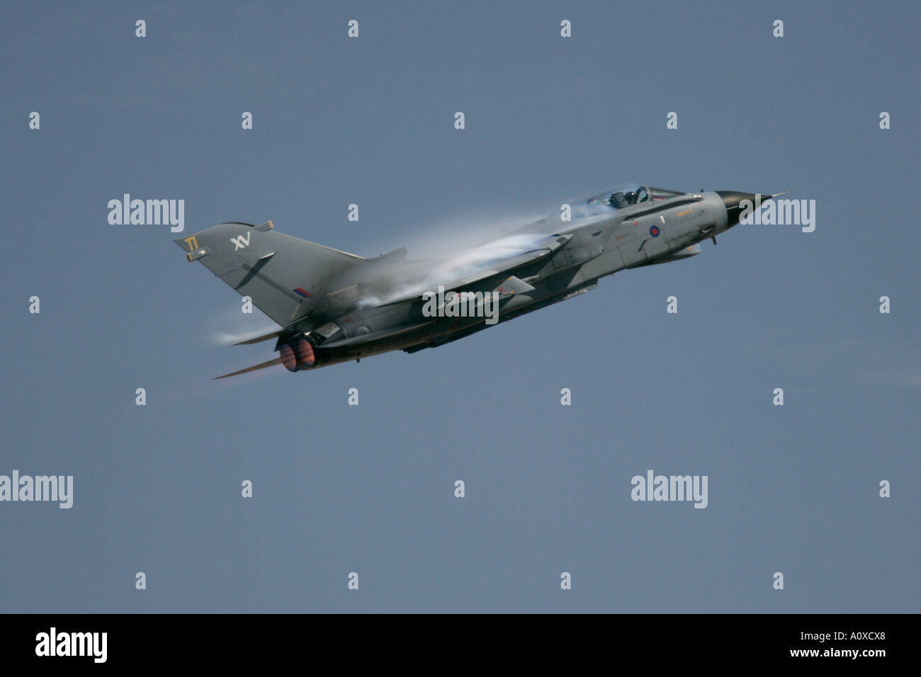 RAF Tornado GR4 flies against blue sky with wing vapour vortices Stock Photo
