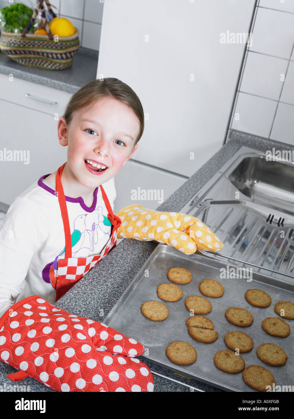 Girl baking biscuits Stock Photo Alamy