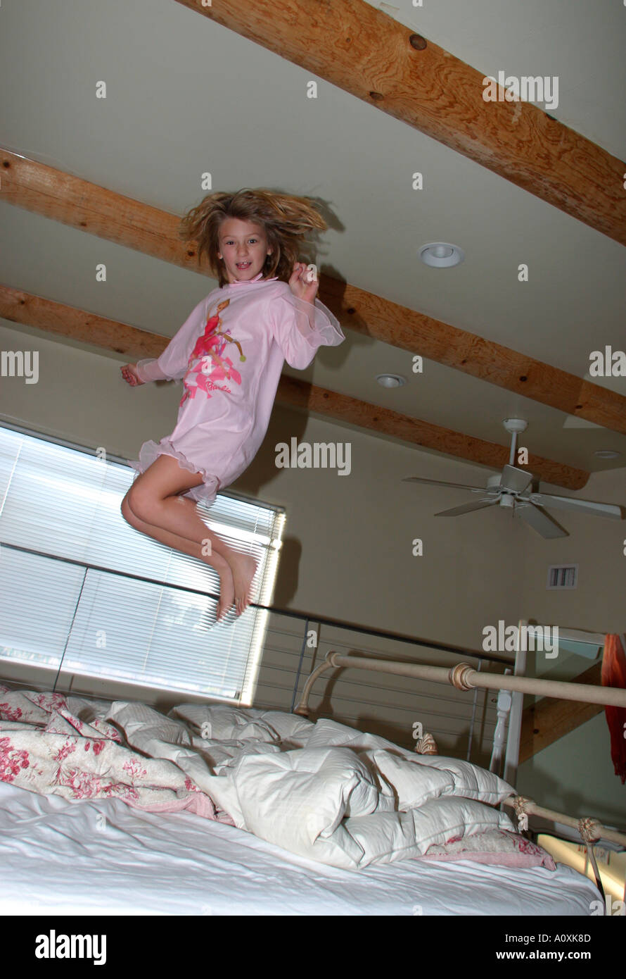 children jumping on bed Stock Photo