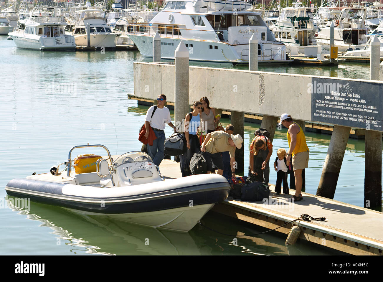 MEXICO Cabo San Lucas Harbor tender bring people to dock power boats in ...