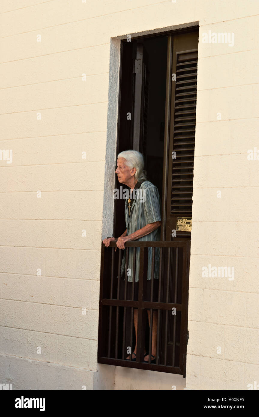 PUERTO RICO San Juan Older woman stand in full length wall opening Old San Juan Stock Photo