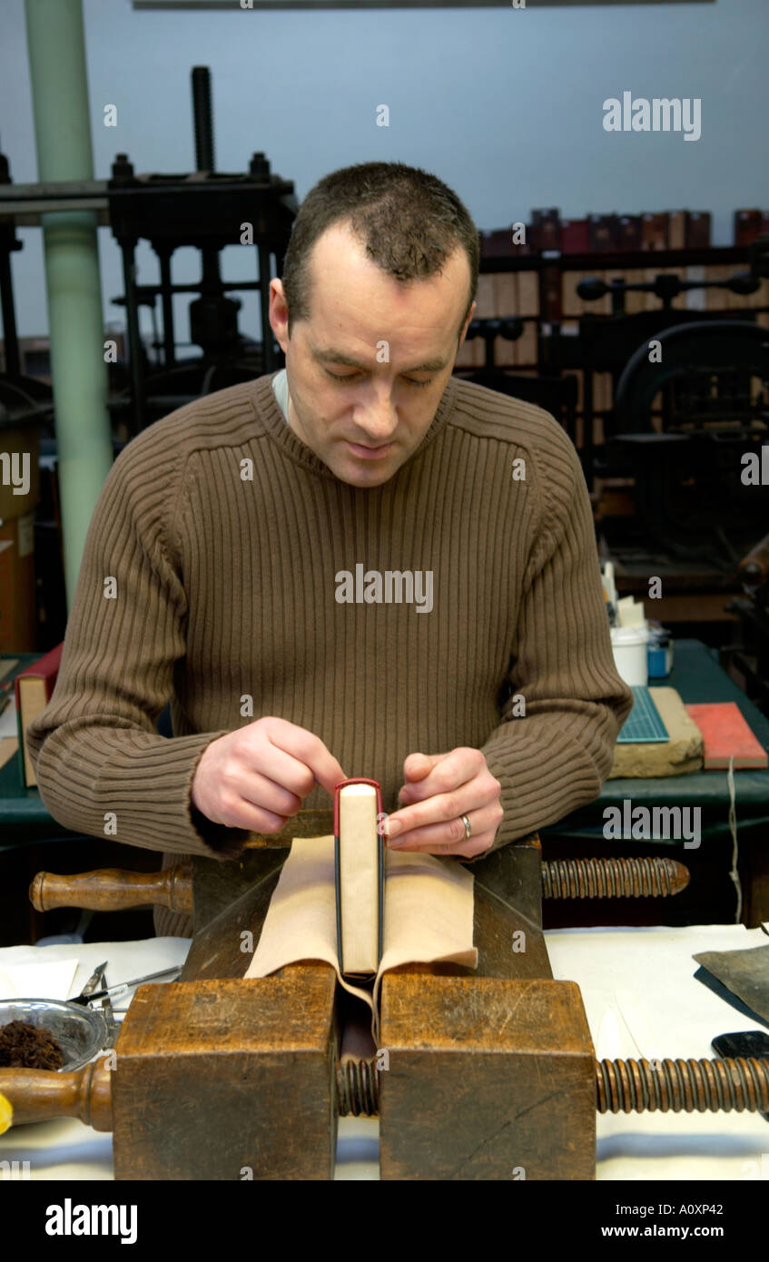 Craftsman working on a book at the Bayntun book bindery Bath