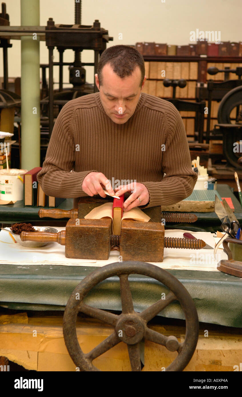 Craftsman working on a book at the Bayntun book bindery Bath