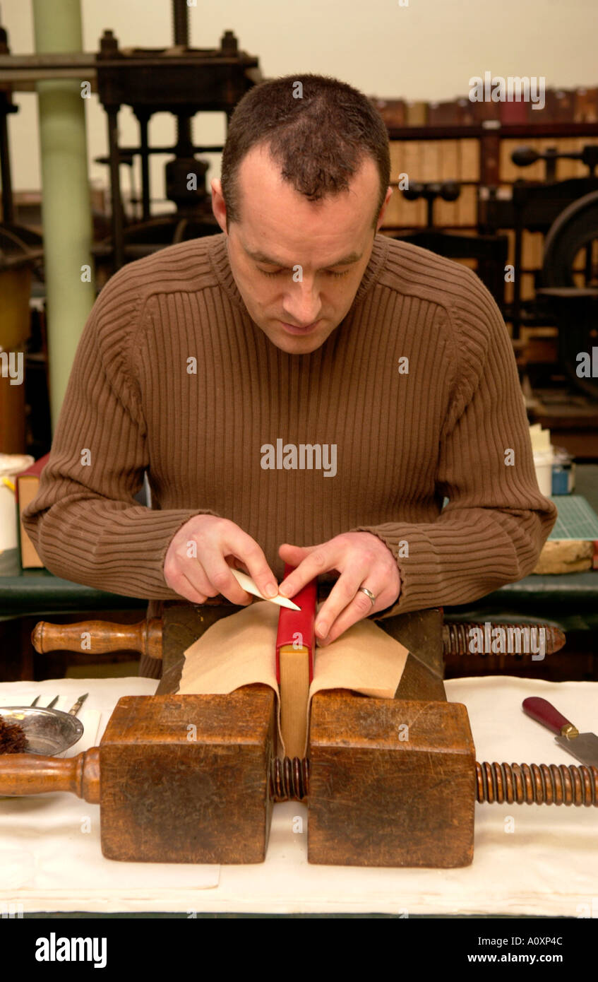Craftsman working on a book at the Bayntun book bindery Bath